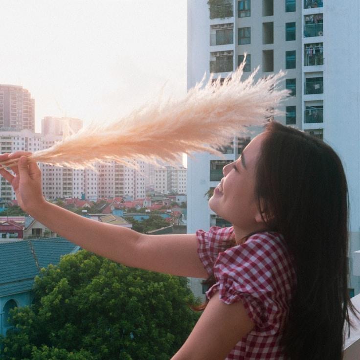 Ava Singh, Lead Design Curator at BeaconMeadowArt, reviewing corporate floral arrangements